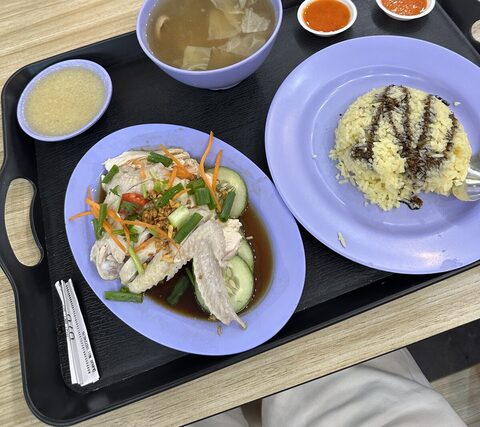Steamed chicken, seasoned rice, soup, and chilli sauces at Katong Mei Wei Chicken Rice